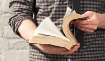 Person opening a Bible (for In-Depth Edition link)